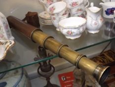 A leather cased four draw brass telescope