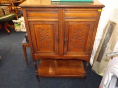 An early 20thC. mahogany cupboard with shelf under