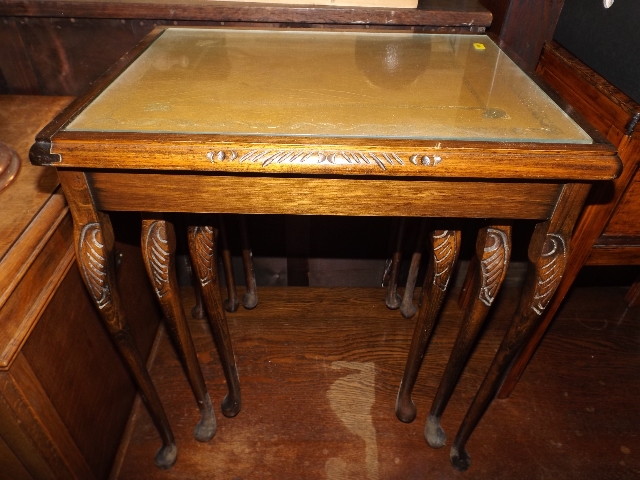 A late 20thC. glass topped nest of tables