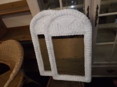 A pair of painted wicker bathroom mirrors