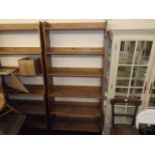 A tall set of open pine book shelves