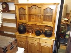 A pine kitchen dresser with glazed cupboards