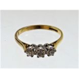 An 18ct gold three stone diamond ring