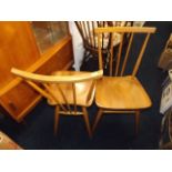 A pair of elm seated Ercol dining chairs