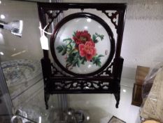 A small mounted woven Oriental screen