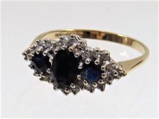 A ladies 9ct gold ring set with diamond & sapphire