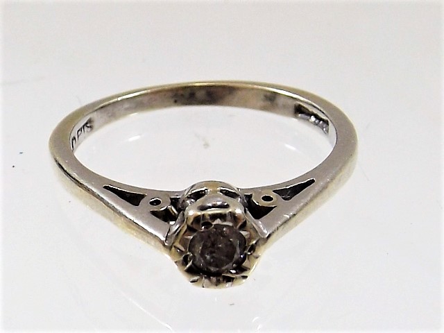 A white metal diamond solitaire ring