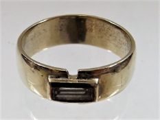 A yellow metal ring set with baguette diamond