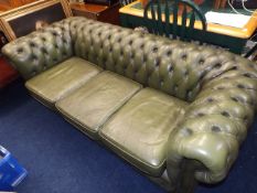 A green leather chesterfield sofa