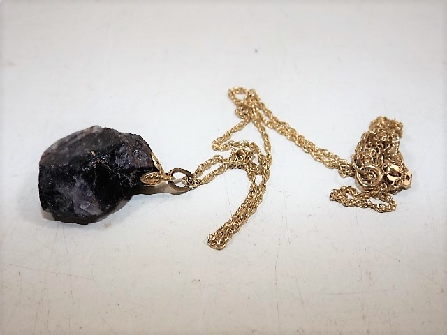 A gold mounted piece of blue john with gold chain