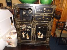 A Chinese cabinet with applied decor