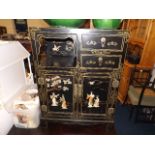 A Chinese cabinet with applied decor