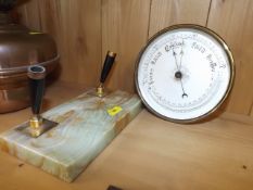 A brass barometer twinned with 1970's onyx pen sta