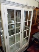 A contemporary glazed display cabinet with glass s