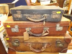 Three small leather suitcases