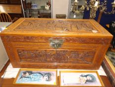 An oriental carved camphor wood chest