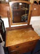 A small oak dressing table with mirror