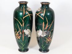 A pair of Cloisonne vases depicting wading birds
