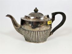 An English silver teapot with gadrooned body & lid