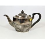 An English silver teapot with gadrooned body & lid