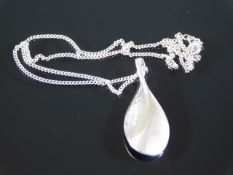 A stylised silver tear drop & chain