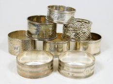 Eight silver napkin rings including two matching
