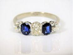 A c.1900 18ct white gold ring set with approx. 1ct of lively diamonds & two sapphires