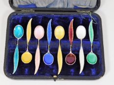 A boxed set of eight silver enamelled tea spoons