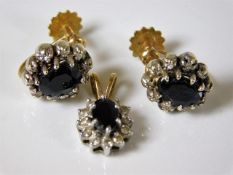 A diamond & sapphire ear ring & pendant set