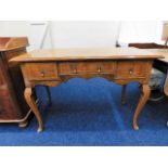 A 1920's walnut veneered low boy with three drawer