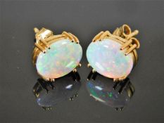 A pair of yellow metal style opal ear rings