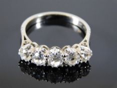 An antique 18ct gold ring with five diamonds appro