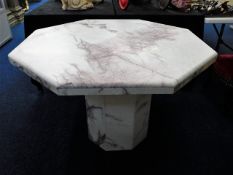 An octagonal marble dining table