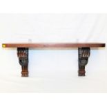 An antique mahogany shelf with gadrooned supports