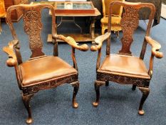 A pair of his & hers 18thC. walnut chairs with carved splats & carved eagle style decor to arms
