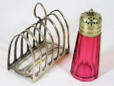 A cranberry glass sifter twinned with silver plate