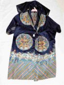 A Chinese silk gown with detailed embroidered roundels featuring Imperial dragons & Taoist swastika
