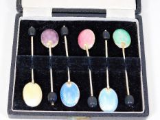 A set of six enamelled silver coffee bean spoons