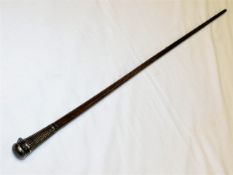A gents walking cane with white metal topped flask