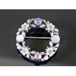 A white metal brooch set with amethyst & carved moonstone