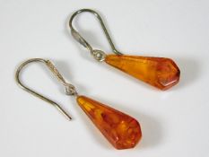 A pair of silver mounted amber ear rings