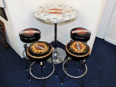 A Harley Davidson bar table with stools