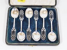 A boxed set of silver spoons with ecclesiastical h