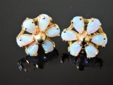 A pair of yellow metal daisy style opal ear rings