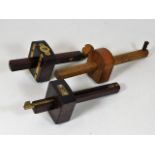 Two rosewood & brass gauges & one other
