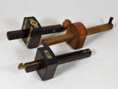 Two rosewood & brass gauges & one other