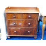 A small Victorian chest of drawers with galleried