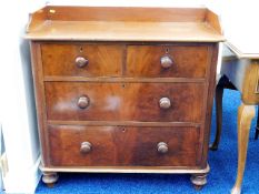 A small Victorian chest of drawers with galleried