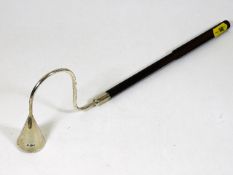 A silver candle snuffer