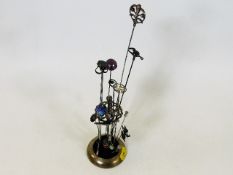 A Victorian hat pin stand with pins including some